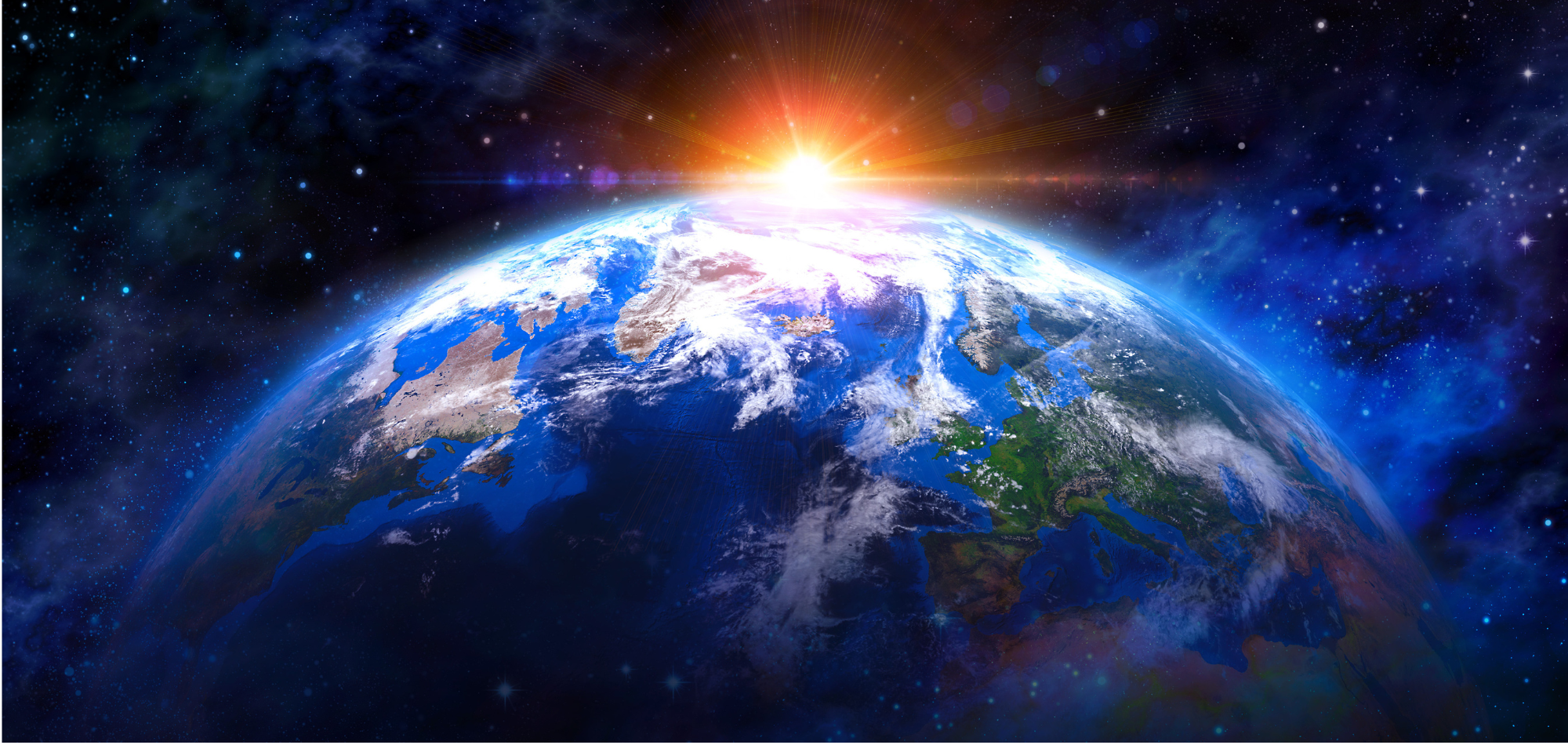 Earth seen from space as the sun rises over the horizon